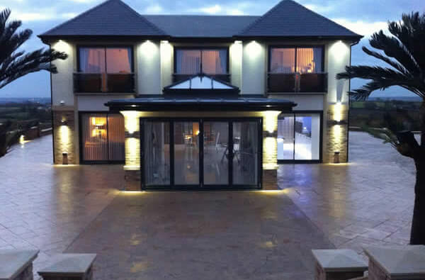 Large modern house drive idea using stamped concrete